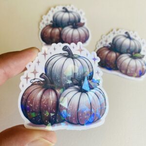 cute aesthetic holographic sticker with three pastel pumpkins and sparkles