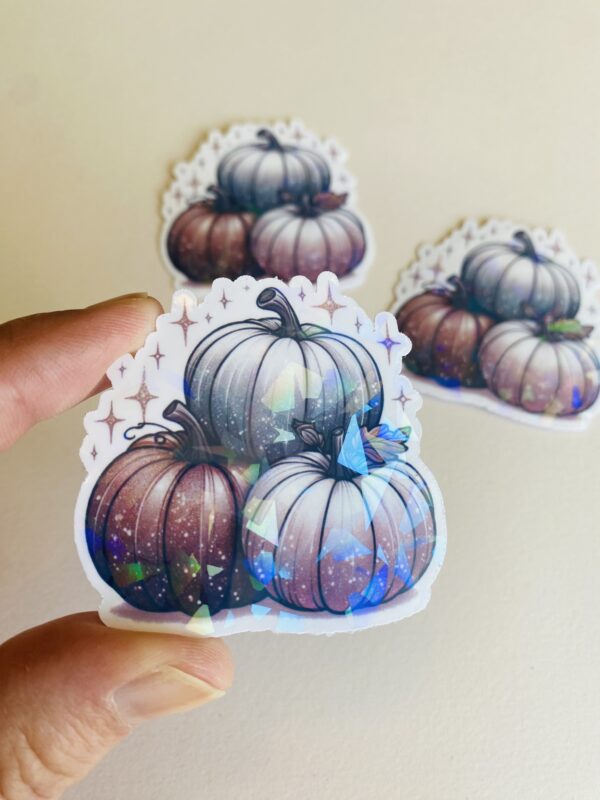 cute aesthetic holographic sticker with three pastel pumpkins and sparkles
