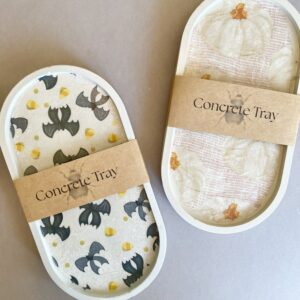 These beautiful concrete trays are a great decor accessory for the fall and halloween holiday, featuring pumpkins, bat bows and candy corn